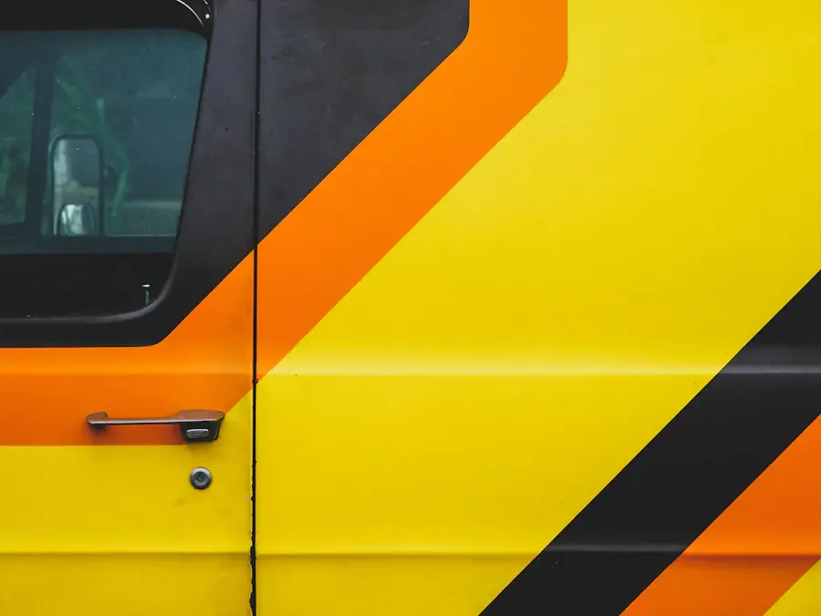 Orange van with black chevron livery, close up